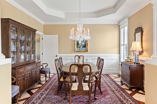 2636 Anchor Watch Dr, Wadmalaw Island, SC 29487 - dining area featuring a tray ceiling, an inviting chandelier, and a wainscoted wall