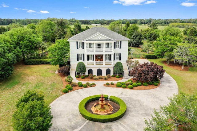 2636 Anchor Watch Dr, Wadmalaw Island, SC 29487 - greek revival house with covered porch, curved driveway, a front lawn, a balcony, and stairs