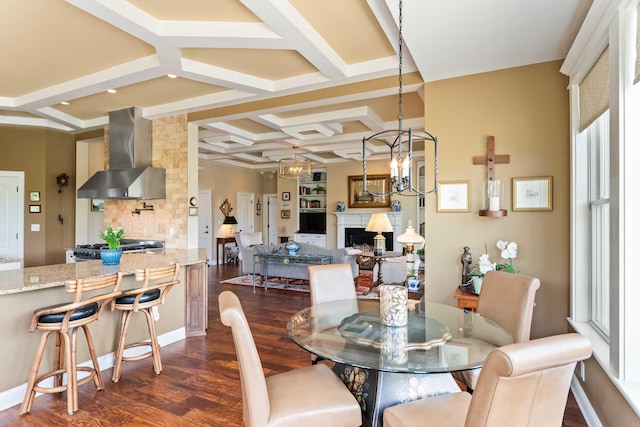 2636 Anchor Watch Dr, Wadmalaw Island, SC 29487 - dining area featuring a notable chandelier, coffered ceiling, dark wood finished floors, a fireplace, and beam ceiling