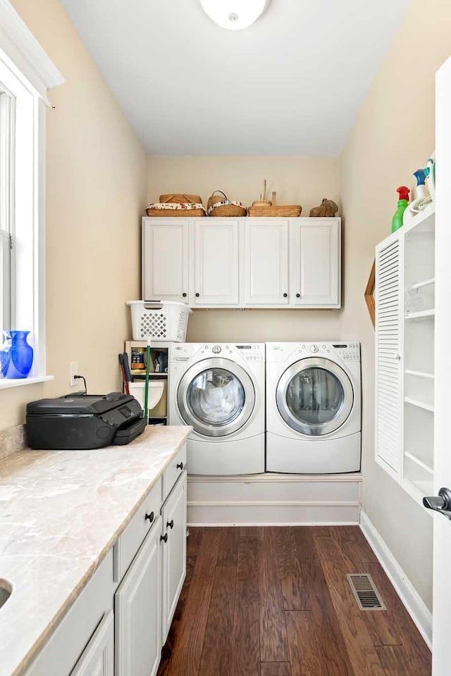 2636 Anchor Watch Dr, Wadmalaw Island, SC 29487 - clothes washing area featuring cabinet space, washing machine and clothes dryer, dark wood finished floors, and visible vents