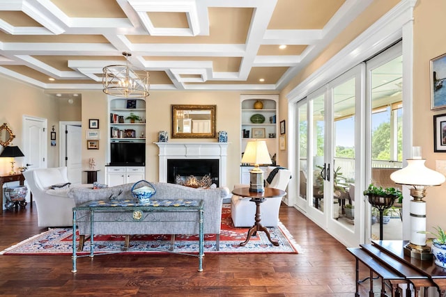 2636 Anchor Watch Dr, Wadmalaw Island, SC 29487 - living room featuring wood finished floors, coffered ceiling, a chandelier, built in shelves, and a warm lit fireplace