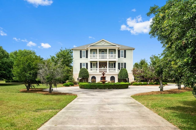 2636 Anchor Watch Dr, Wadmalaw Island, SC 29487 - neoclassical home featuring a balcony, a front yard, and curved driveway