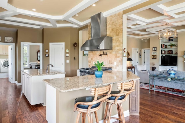 2636 Anchor Watch Dr, Wadmalaw Island, SC 29487 - kitchen featuring coffered ceiling, a center island with sink, high end range, wall chimney range hood, and washer / clothes dryer