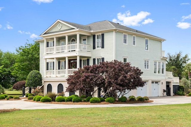 2636 Anchor Watch Dr, Wadmalaw Island, SC 29487 - view of front facade with driveway, a garage, a front lawn, and a balcony