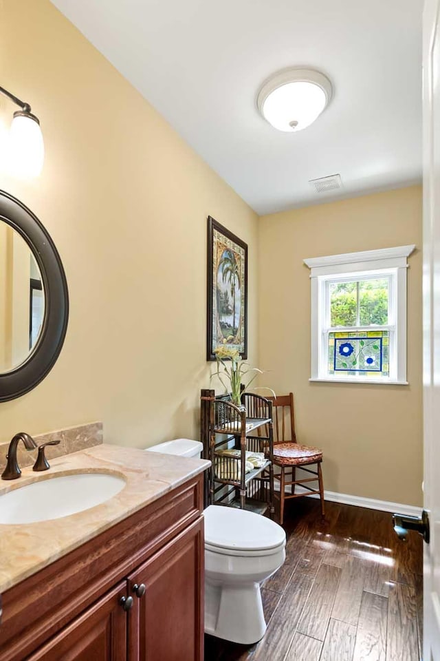 2636 Anchor Watch Dr, Wadmalaw Island, SC 29487 - bathroom with toilet, baseboards, visible vents, vanity, and hardwood / wood-style flooring