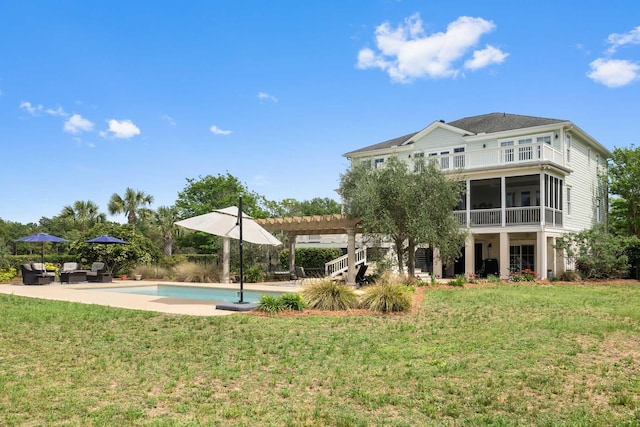 2636 Anchor Watch Dr, Wadmalaw Island, SC 29487 - rear view of house with a pergola, a patio area, an outdoor pool, and a lawn