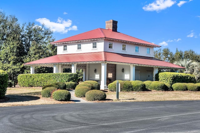 2636 Anchor Watch Dr, Wadmalaw Island, SC 29487 - view of front of property with covered porch, a chimney, and metal roof