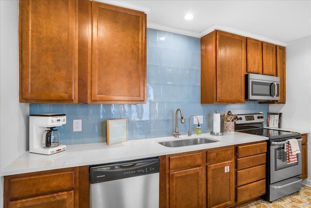 kitchen featuring decorative backsplash, light stone counters, stainless steel appliances, crown molding, and sink