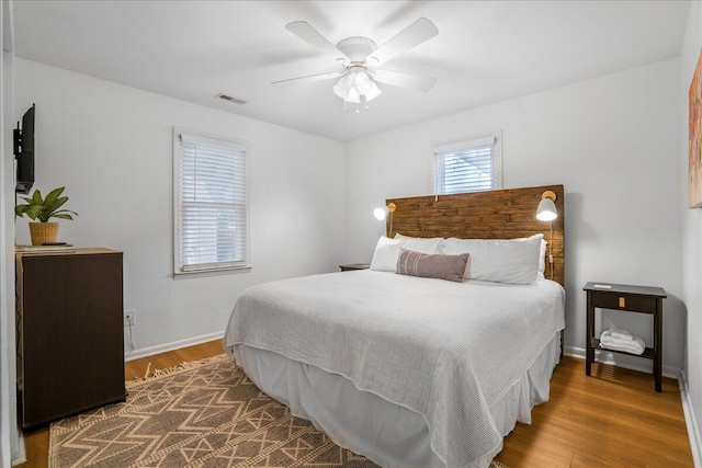 bedroom with ceiling fan and dark hardwood / wood-style floors