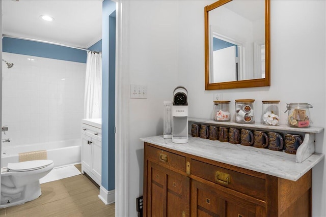 full bathroom featuring shower / bath combo with shower curtain, vanity, and toilet