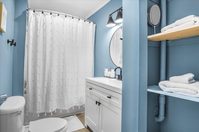 full bathroom featuring vanity, toilet, crown molding, and shower / tub combo