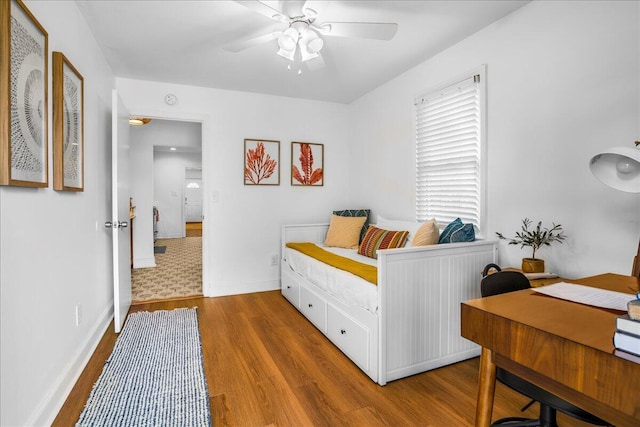 bedroom with wood-type flooring and ceiling fan