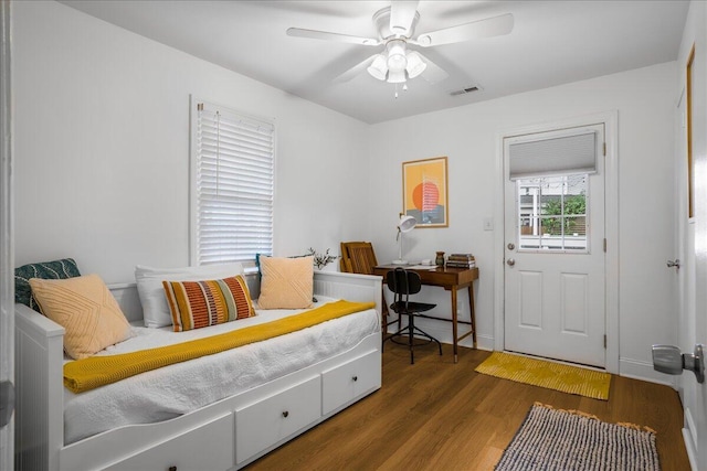 bedroom with ceiling fan and dark wood-type flooring