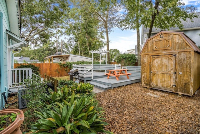 exterior space featuring a shed and a wooden deck