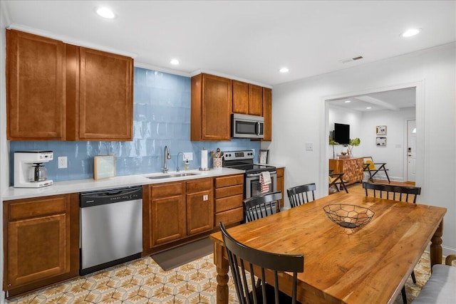 kitchen with backsplash, stainless steel appliances, and sink