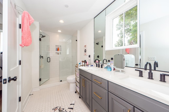 bathroom featuring vanity, toilet, tile patterned floors, and a shower with door