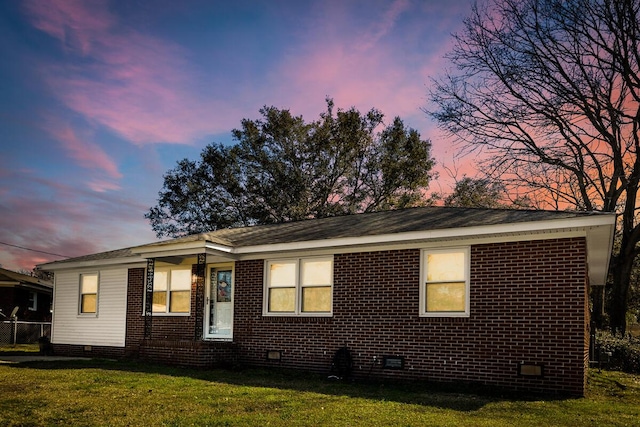 view of home's exterior featuring crawl space, brick siding, and a yard