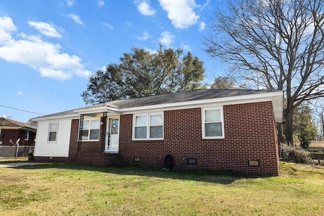 exterior space featuring a front lawn, crawl space, and brick siding