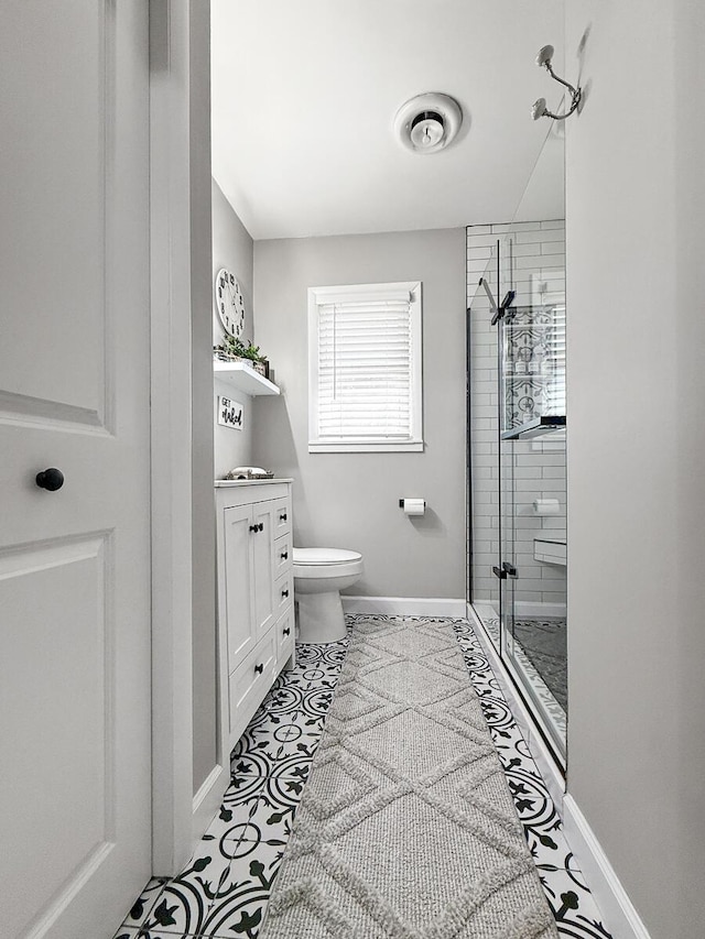 full bathroom with toilet, vanity, baseboards, a shower stall, and tile patterned floors