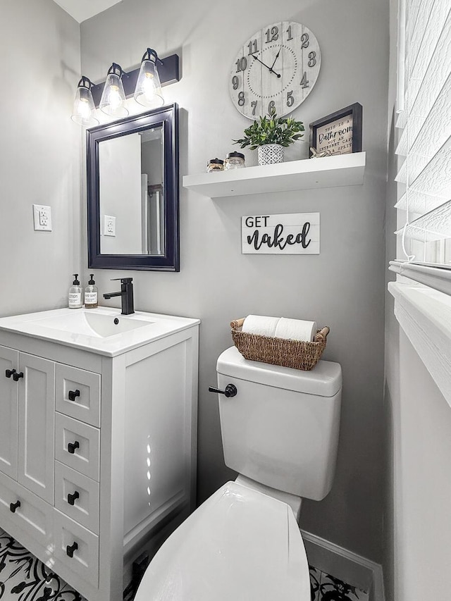 half bathroom with toilet and vanity