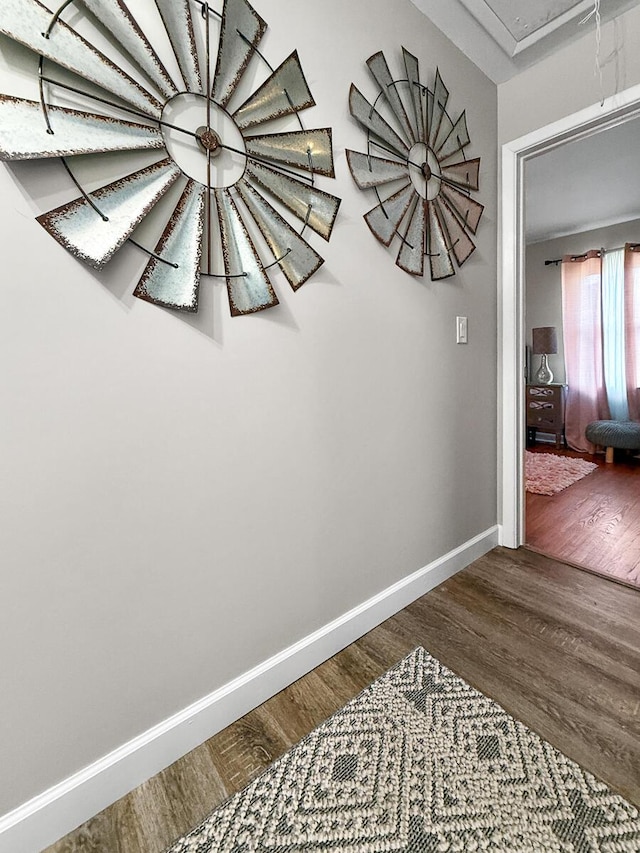 hallway with attic access, baseboards, and dark wood finished floors