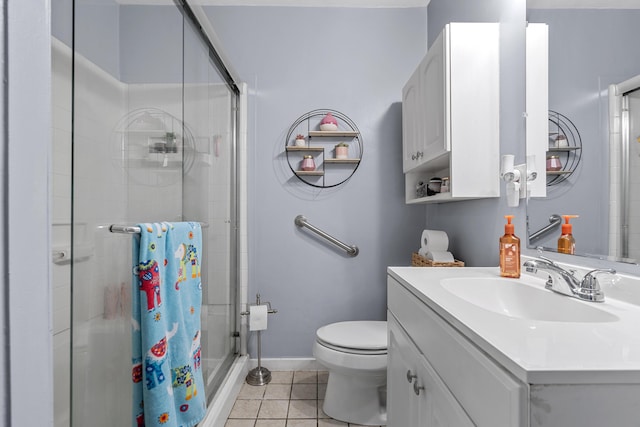 full bathroom featuring tile patterned floors, toilet, a shower stall, baseboards, and vanity