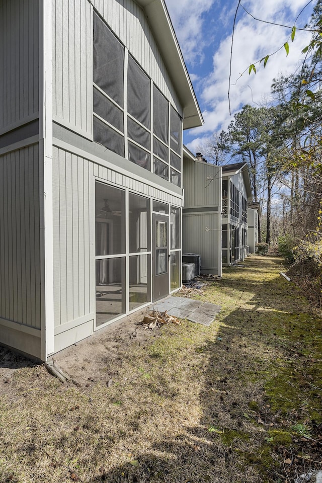 view of property exterior with a sunroom