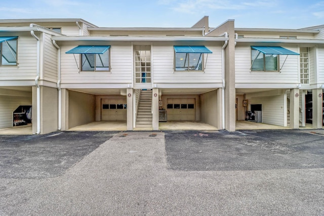 4 Beach Club Villas, Isle Of Palms, SC 29451 - townhome / multi-family property with a carport, stairs, a garage, and asphalt driveway