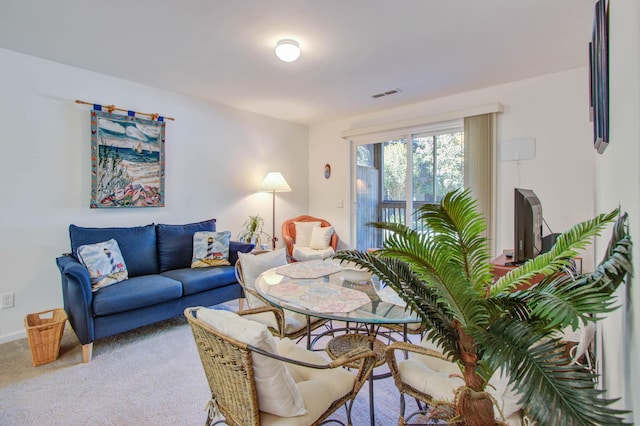 living area with light carpet and visible vents