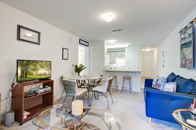 dining area with light carpet and visible vents