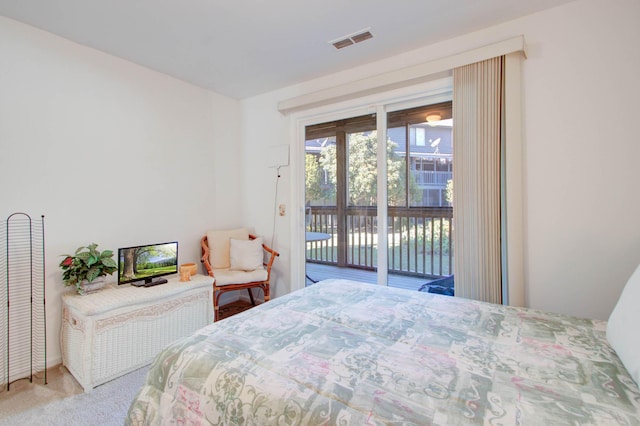 carpeted bedroom featuring access to outside and visible vents