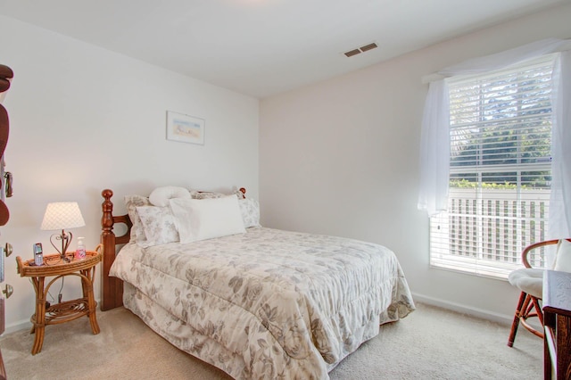 carpeted bedroom with visible vents and baseboards