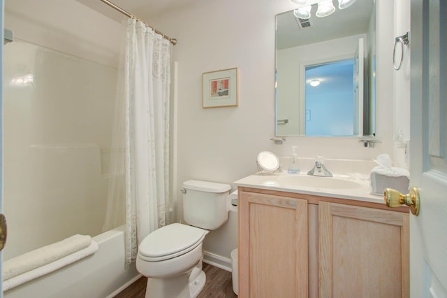 bathroom with visible vents, toilet, shower / bath combo, wood finished floors, and vanity