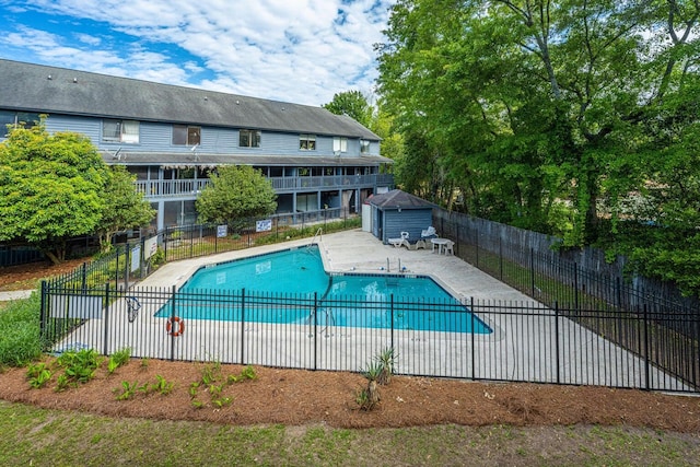 pool with a patio and fence