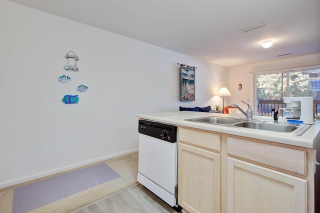 kitchen featuring visible vents, open floor plan, light countertops, white dishwasher, and a sink