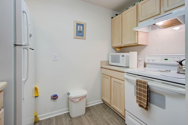 kitchen featuring light wood-type flooring, light brown cabinetry, under cabinet range hood, white appliances, and baseboards