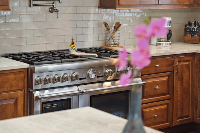 kitchen featuring stainless steel stove and decorative backsplash