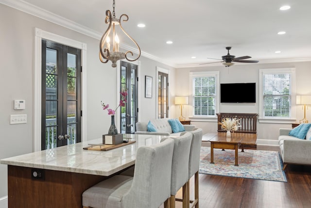 dining area with a wealth of natural light, dark hardwood / wood-style floors, and french doors