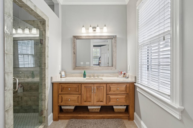 bathroom featuring a shower with door, plenty of natural light, ornamental molding, and vanity