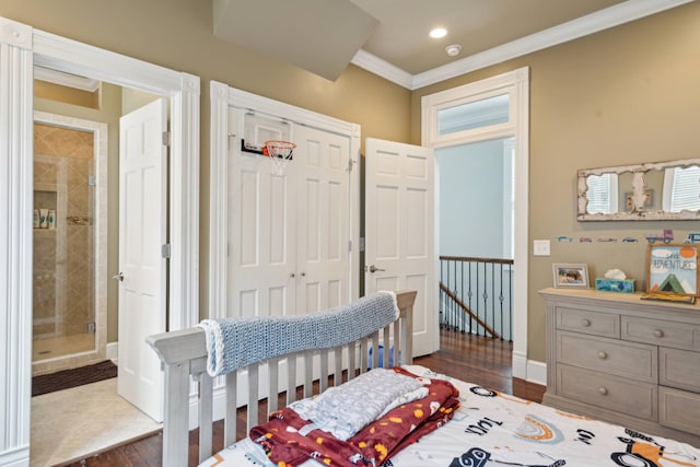 bedroom featuring ornamental molding, dark hardwood / wood-style floors, and a closet