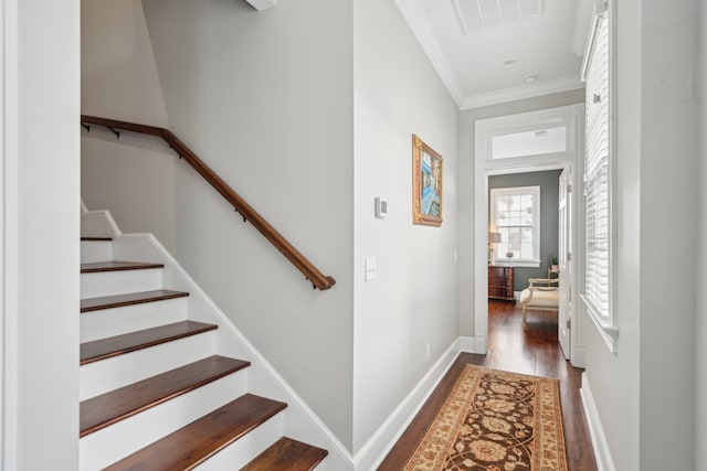 staircase featuring hardwood / wood-style flooring and ornamental molding