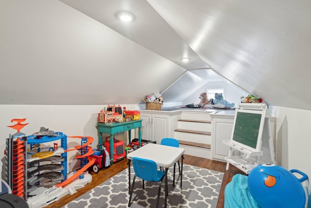 game room featuring dark wood-type flooring and vaulted ceiling