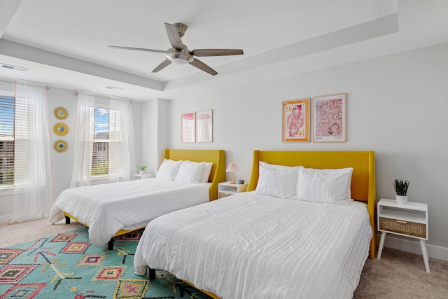 4585 Summey St, North Charleston, SC 29405 - carpeted bedroom with a tray ceiling, ceiling fan, and baseboards