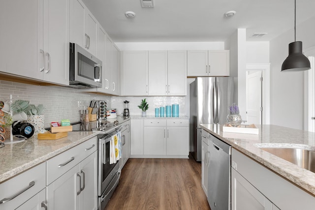 4585 Summey St, North Charleston, SC 29405 - kitchen featuring stainless steel appliances, dark wood-style flooring, hanging light fixtures, and white cabinetry