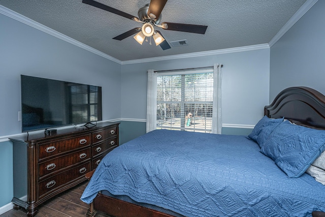 bedroom with visible vents, dark wood finished floors, a textured ceiling, and ornamental molding