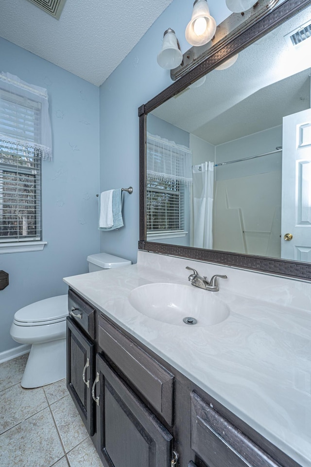 bathroom with a textured ceiling, toilet, a shower with shower curtain, vanity, and visible vents