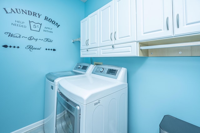 laundry room with independent washer and dryer, cabinet space, and baseboards