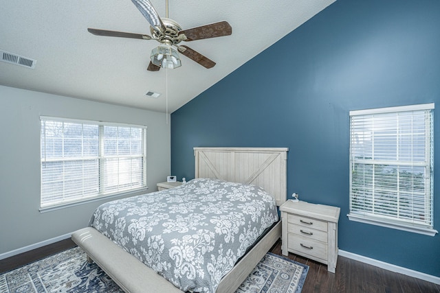 bedroom featuring lofted ceiling, baseboards, visible vents, and dark wood-type flooring