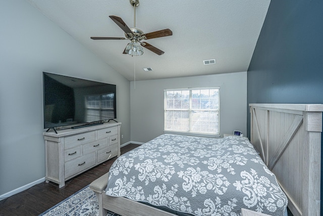 bedroom with lofted ceiling, visible vents, dark wood-type flooring, ceiling fan, and baseboards