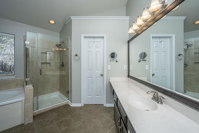 full bath with a stall shower, a garden tub, a textured ceiling, and vanity